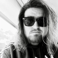 Mitchell Jae's profile pic - their sunglasses-wearing face in black and white
